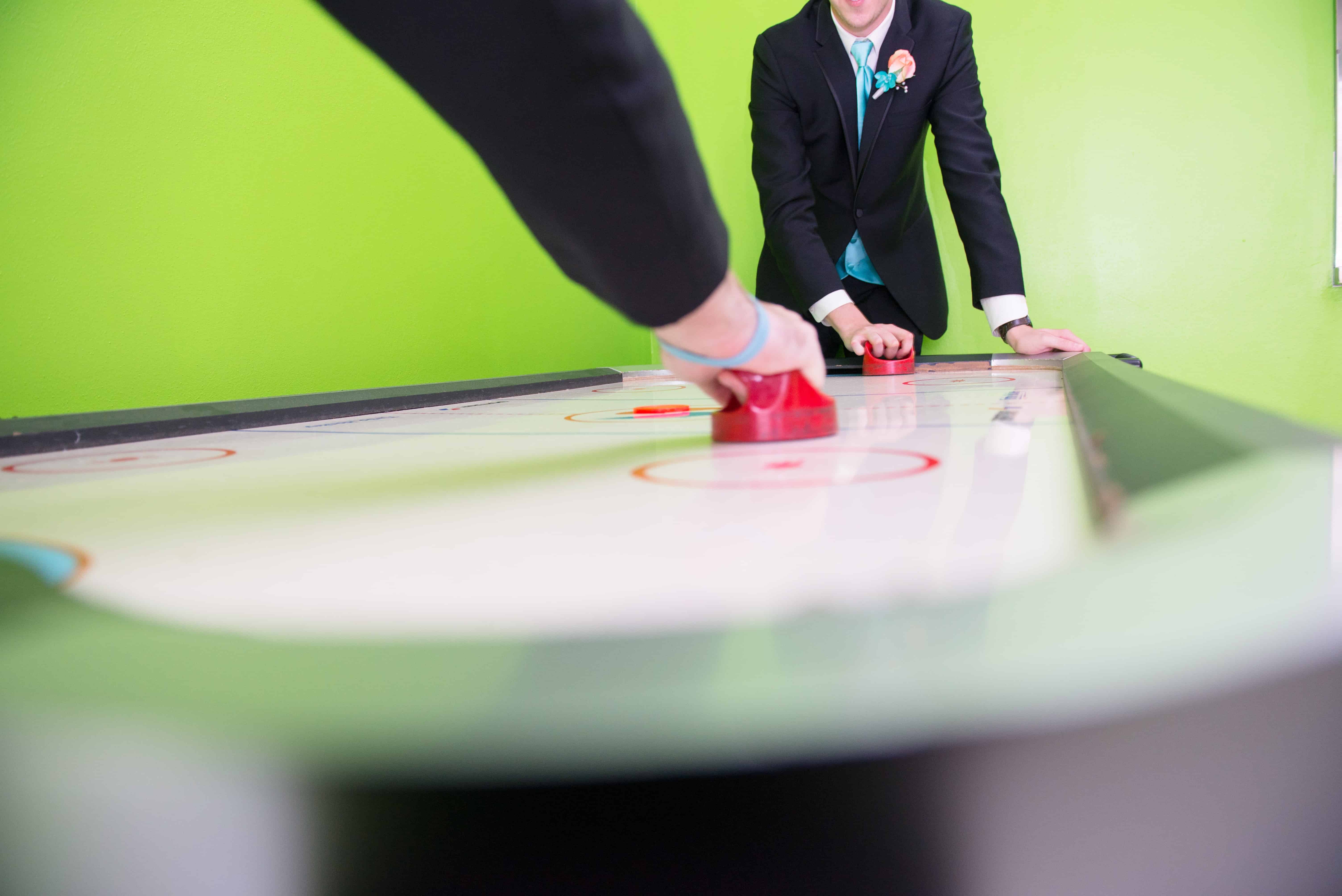 two people playing air hockey