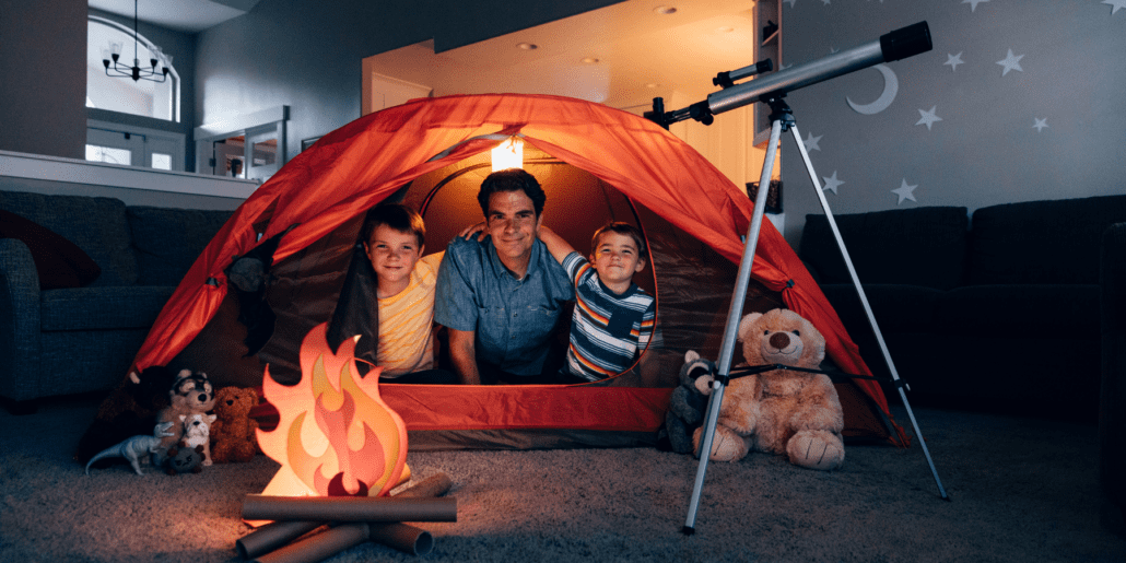 kids and dad doing indoor camping