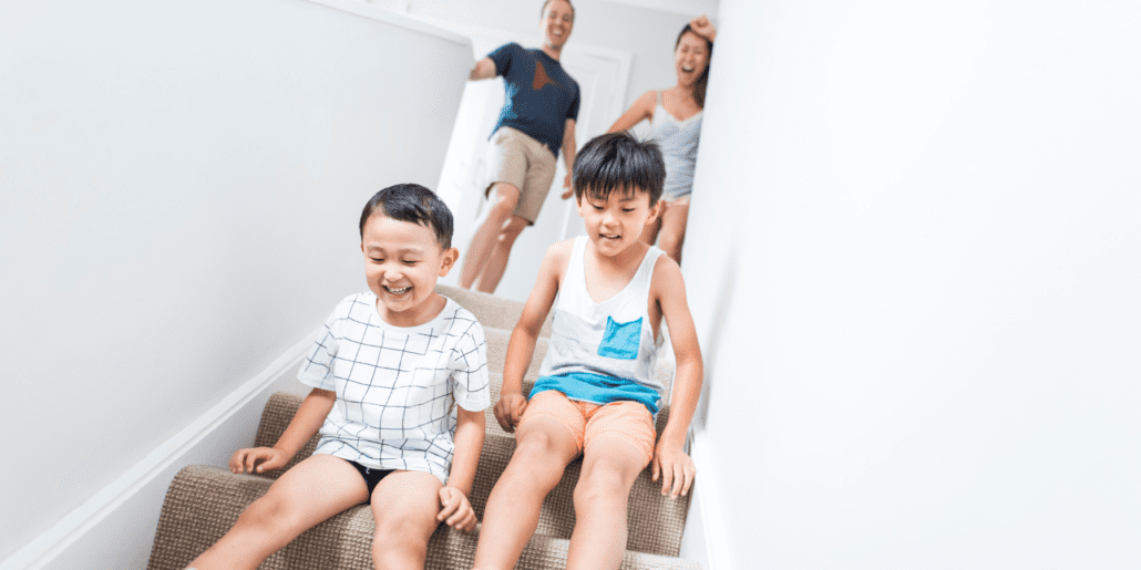 kids sliding down stairs
